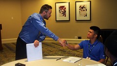 College Division Representative-Northeast Region Ira Thor of New Jersey City University visiting with a a young CoSIDA member.